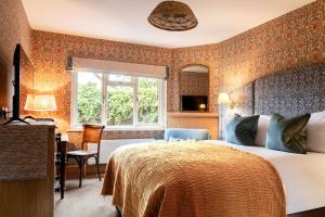a hotel room with a bed and a window at Bel and The Dragon-Cookham in Cookham