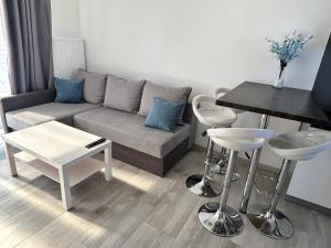 a living room with a couch and a table at Villa Over Lake in Mielno