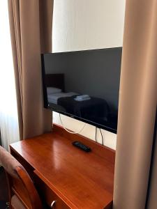 a television sitting on top of a wooden desk at Akme APARTMENTS & ROOMS & FREE PARKING in Gdańsk +57 photos