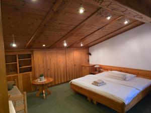 a bedroom with a large bed and a table at Ferienwohnung Felder in Bürs