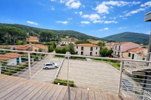 a small white car parked on a balcony of a town at Casa Sveva al Cavo in Cavo