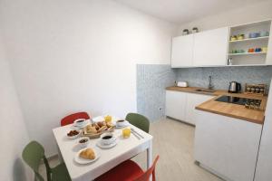 a kitchen with a table with a plate of food on it at Casa Sveva al Cavo in Cavo +5 photos