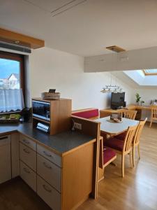 a kitchen and living room with a table and a dining room at Ferienwohnung Felder in Bürs +5 photos