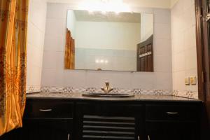 a bathroom with a sink and a large mirror at Proxima Quarters in Rawalpindi +23 photos