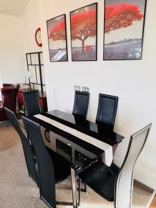 a black piano sitting in a room with chairs at The Shelbourne in Southport
