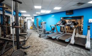 a gym with lots of tread machines and blue walls at Beverley Park in Goodrington