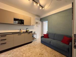 a living room with a gray couch and red pillows at Cozy Apartments and Rooms in Caselle di Sommacampagna