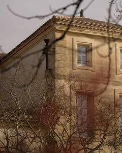 a building with a window on the side of it at Château Fonroque - Camomille in Saint-Émilion