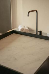 a bathroom counter with a sink and a towel at Château Fonroque La Suite in Saint-Émilion