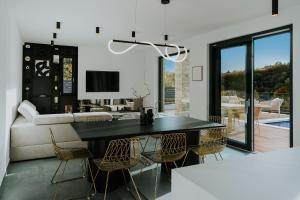 a living room with a black table and chairs at Villa Slowave in Balatonalmádi