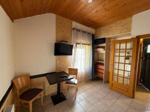 a kitchen with a table and chairs in a room at Auberge Restaurant La Roseraie in Grandrupt