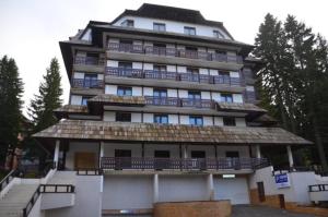 a large building with balconies on top of it at Apartments Vanja i Vrh in Kopaonik