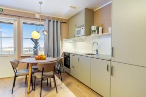 a kitchen with a table and chairs and a sink at Simloc Hotel Öberget in Arjeplog