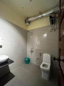a bathroom with a toilet and a sink at Prangan - The Villa in Chākdaha +65 photos