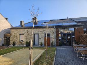 a house with a tree in front of it at Le Cerf d'Or in Herbeumont