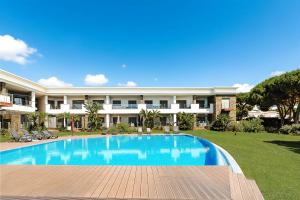 a swimming pool in front of a building at Apartment Belharucas in Albufeira