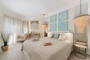 a bedroom with a large bed with two towels on it at Apartment Belharucas in Albufeira +105 photos
