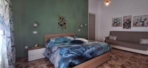 a bedroom with a bed and a couch in it at Stella Bianca in Giulianova
