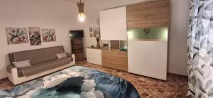 a living room with a couch and a bed in a room at Stella Bianca in Giulianova