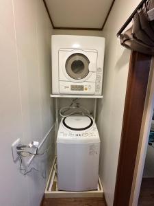 a washer and dryer in a small room at My Chalet Hakuba in Hakuba