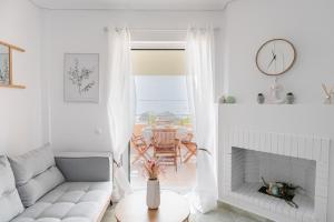 a living room with a couch and a fireplace at CorfuLevante Sea View in Barbati