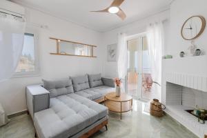 a living room with a couch and a fireplace at CorfuLevante Sea View in Barbati