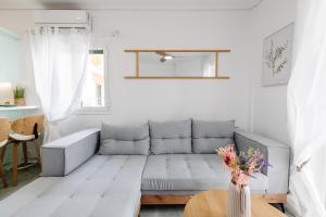a living room with a gray couch and a table at CorfuLevante Sea View in Barbati +33 photos