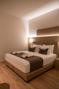 a bedroom with a large bed in a room at Terra Boutique Hotel in Tirana