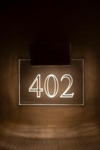 a neon sign with the number on a wall at Terra Boutique Hotel in Tirana
