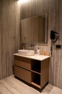 a bathroom with a sink and a mirror at Terra Boutique Hotel in Tirana +86 photos