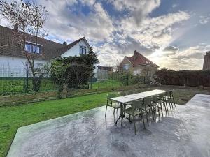 a table and chairs sitting on top of a patio at Villa Pomone - Sint-Idesbald in Koksijde