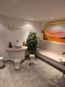 a bathroom with a sink and a bath tub at Sieglhub Chalets - Appartements - Hotel in Flachau +121 photos