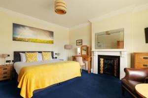 a hotel room with a bed and a fireplace at Northgate House in Buckfastleigh +40 photos