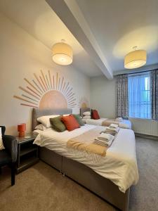 a bedroom with two beds and a sun mural on the wall at The Bar Convent Guest House in York