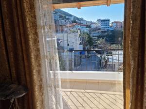 a window with a view of a city at Alban Apartament in Lukovë
