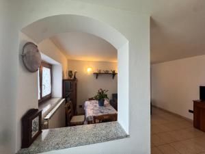 a dining room and living room with an archway at Casa Flory in Verbania