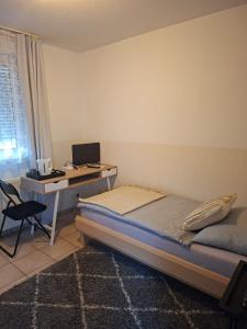 a bedroom with a bed and a desk with a computer at Restaurant Zur Linde in Bergheim