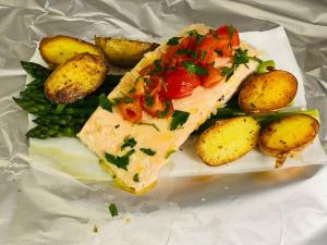 a plate of food with a sandwich and potatoes at Restaurant Zur Linde in Bergheim