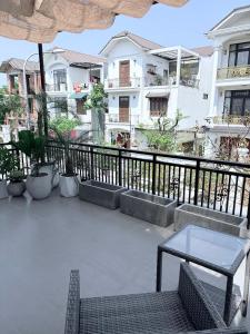 a patio with a table and chairs and some buildings at Cốm Homestay in Hue