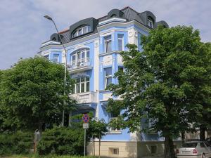 a blue building with a black roof on a street at Family Hotel Belle Epoque Beach in Varna City