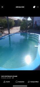 a picture of a large blue swimming pool at Chalés de Tibau in Tibau