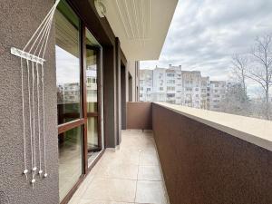 a balcony with a view of a building at Modern Nest Varna - free parking in Varna City