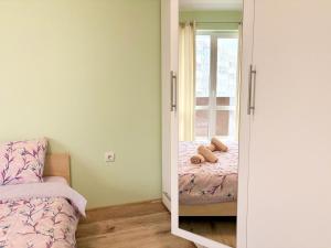 a bedroom with a mirror and a bed with a window at Modern Nest Varna - free parking in Varna City