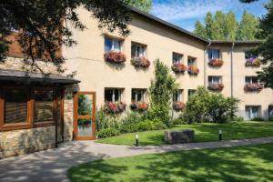 a building with flower boxes on the side of it at Logis Hotel Le Lac in Embrun