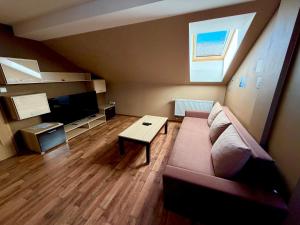 a living room with a couch and a table at Pension Restaurant Bobrovník in Lipova Lazne