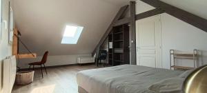 a bedroom with a bed and a desk and a window at Logement 1 - proche Le Mans in Aigné +2 photos