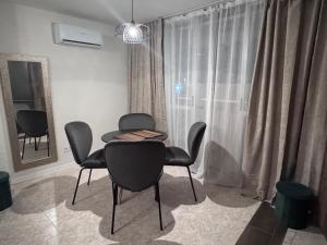 a dining room with chairs and a table and a window at Araya Apartments in Benidorm +28 photos