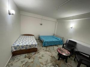 a room with two beds and a piano at Bagaicha Farms in Tādong +3 photos