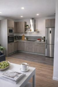 a kitchen with wooden cabinets and stainless steel appliances at Gav Remedios 20 in Ronda