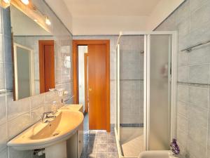 a bathroom with a sink and a shower at Terrazza fra lago e monti in Gravedona +21 photos